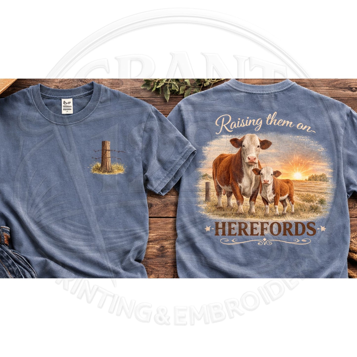 Blue t-shirt with cow design and 'Raising them an Herefords' text on a wooden surface