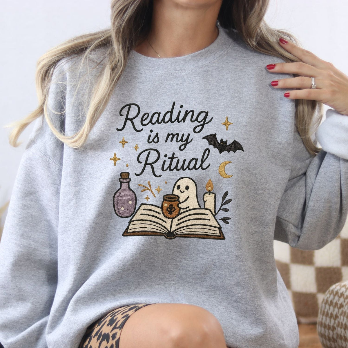 Ash Gildan sweatshirt with embroidered ghost reading a book, candle and potion design