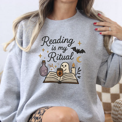 Ash Gildan sweatshirt with embroidered ghost reading a book, candle and potion design