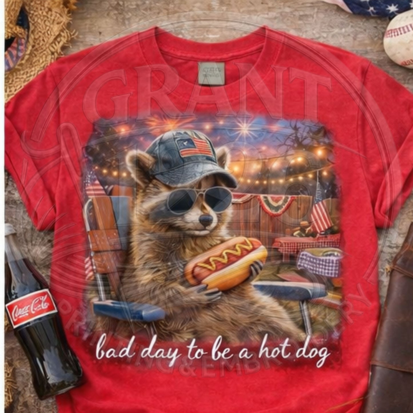 Red 4th of July raccoon graphic tee with patriotic design