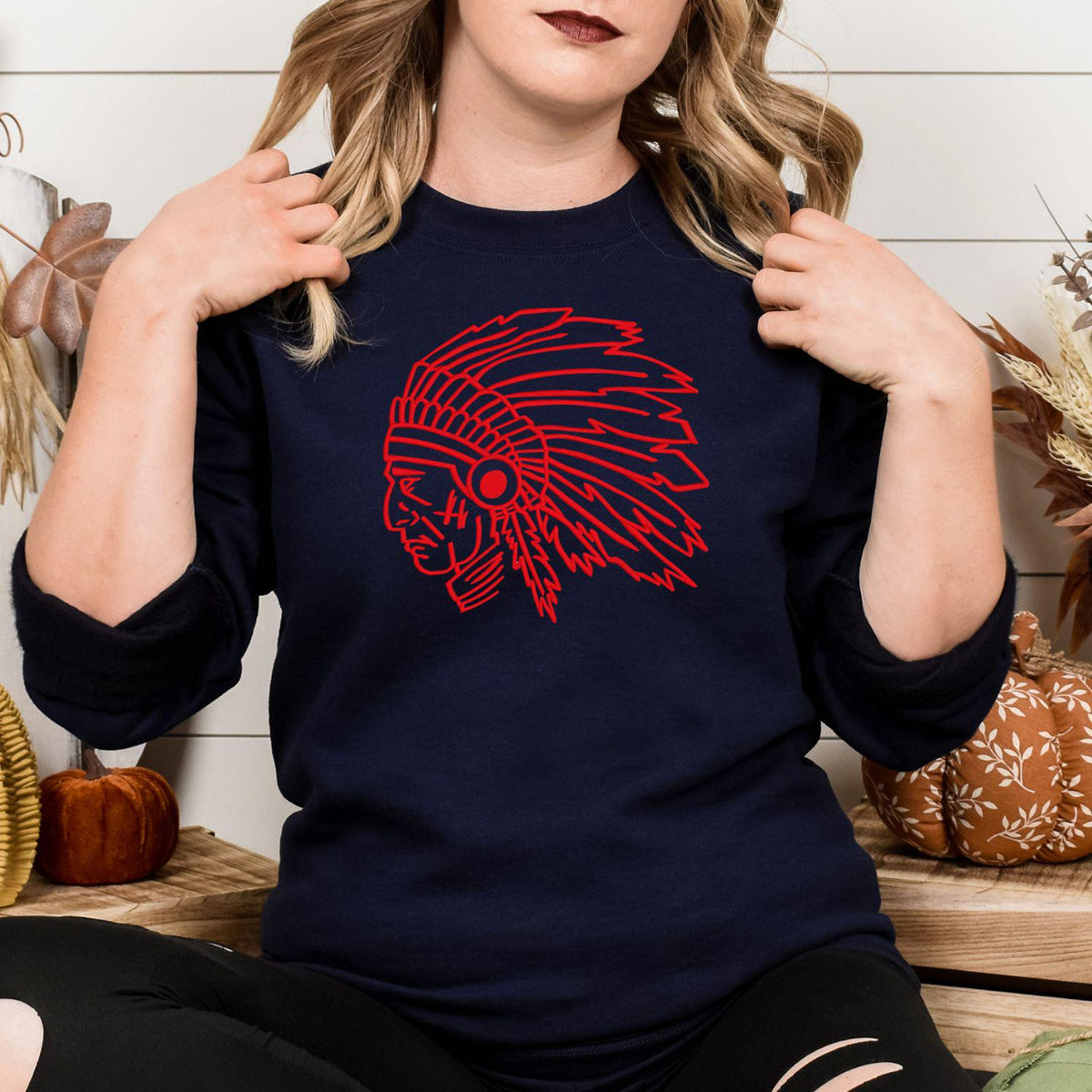 Navy sweatshirt with red headdress mascot embroidery modeled from the front