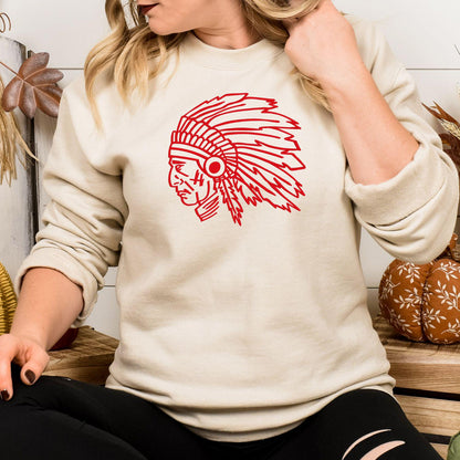 Sand crewneck with a red embroidered headdress mascot modeled indoors