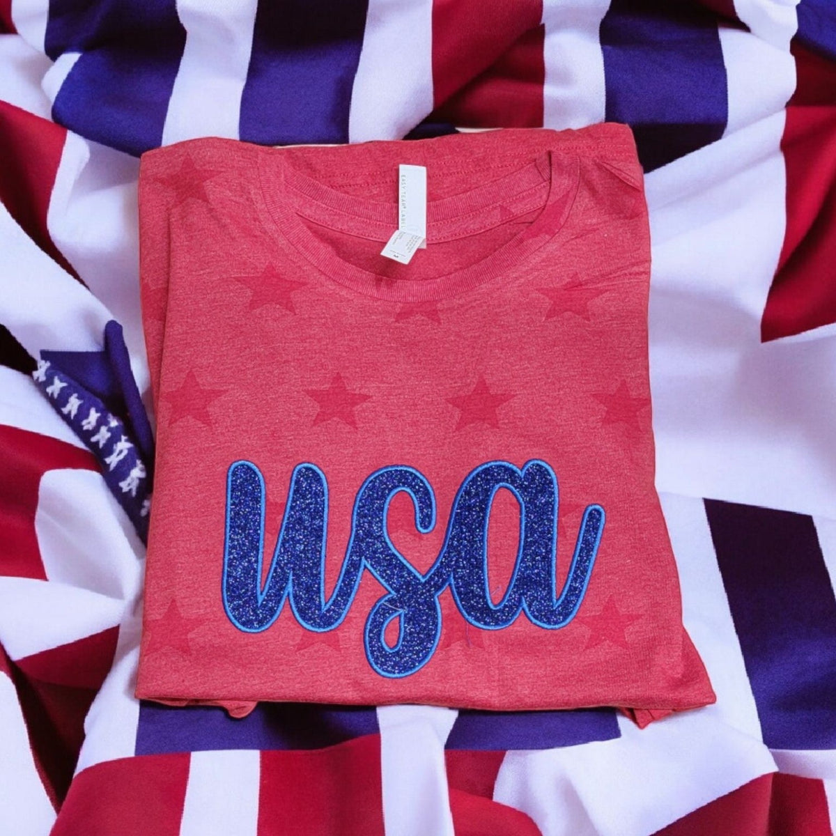 Real Red Star shirt with blue glitter embroidered USA appliqué detail