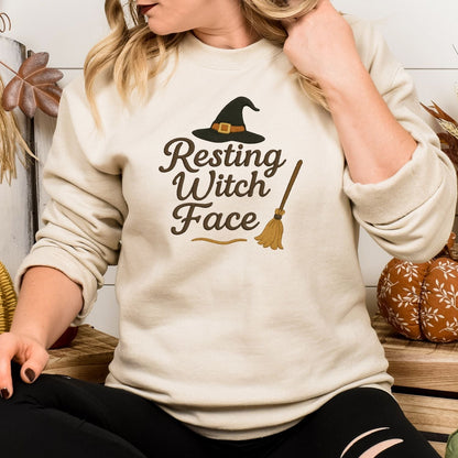 Woman wearing a Sand Resting Witch Face embroidered sweatshirt for Halloween