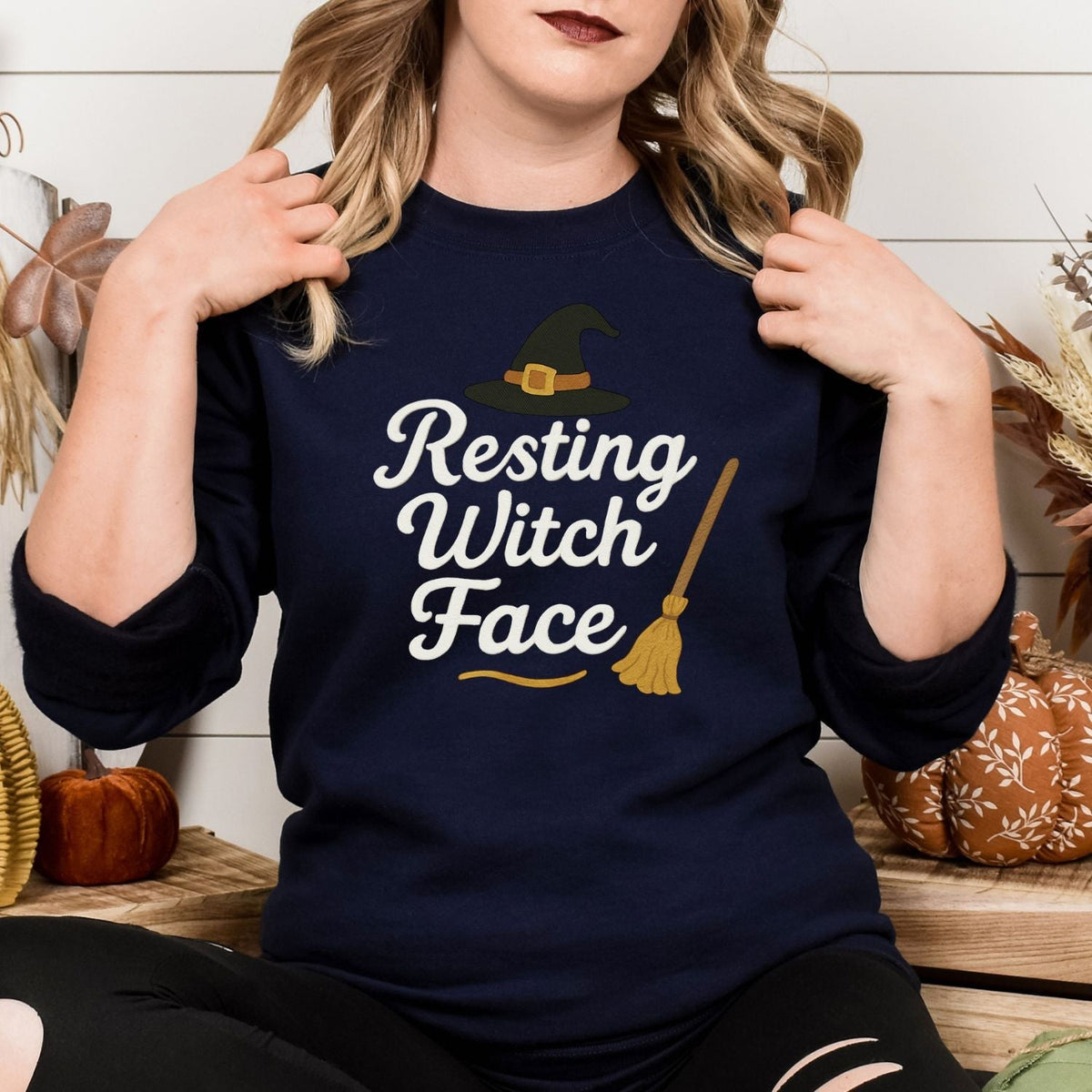 Front view of Navy Resting Witch Face embroidered Halloween crewneck on a model