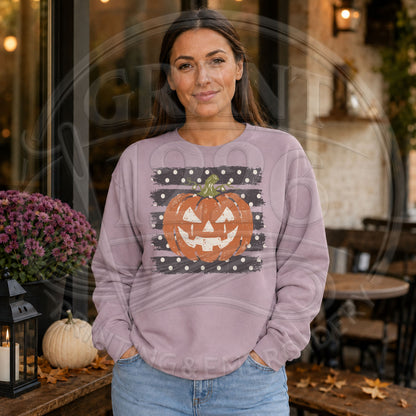 Woman wearing purple retro Halloween sweatshirt with distressed pumpkin face jack o lantern design