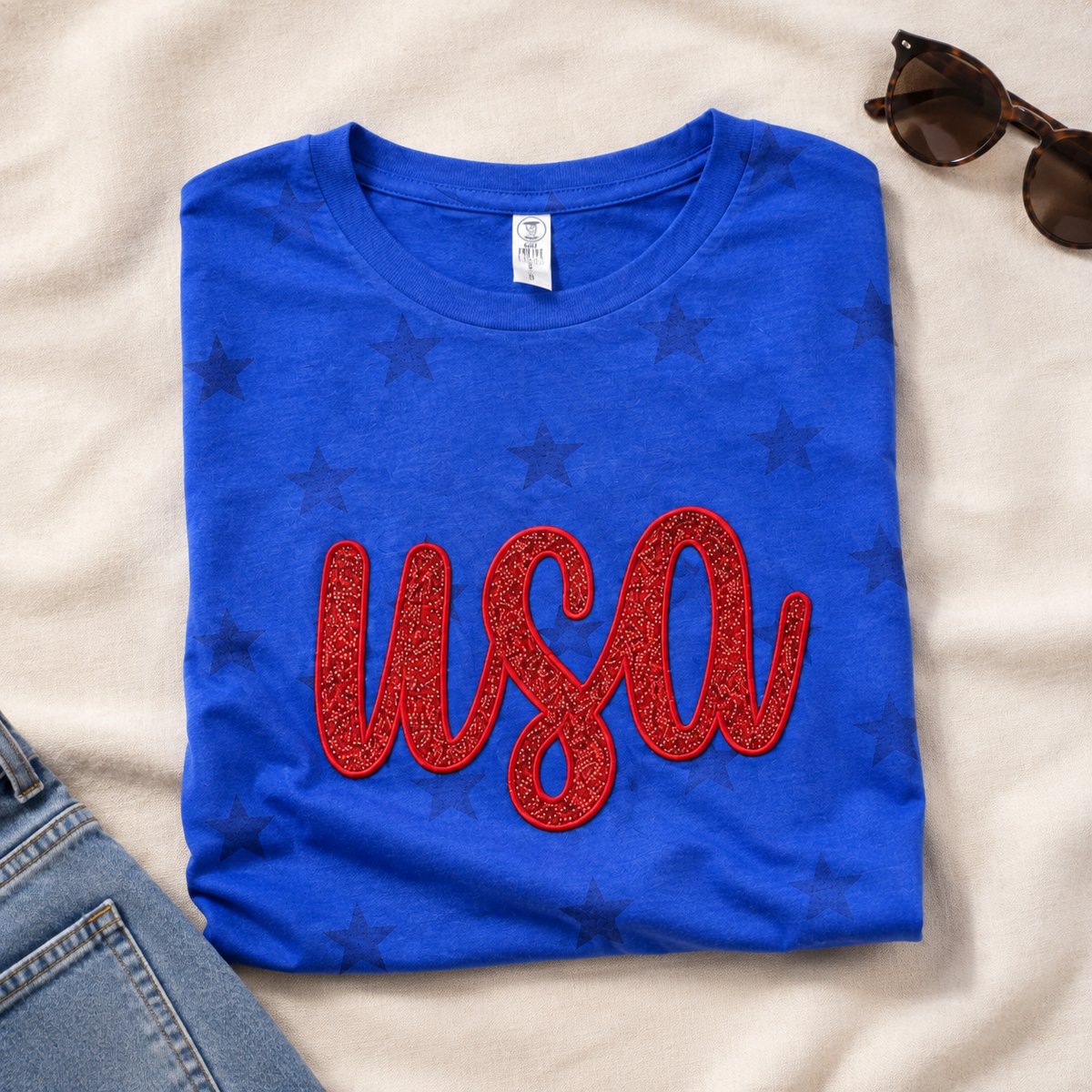 Royal blue patriotic star shirt with red glitter USA appliqué
