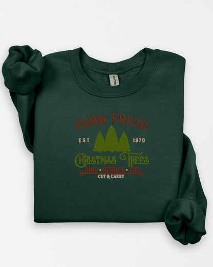 Rustic Farm Fresh Christmas Trees embroidered sweatshirt arranged in a holiday flat lay.