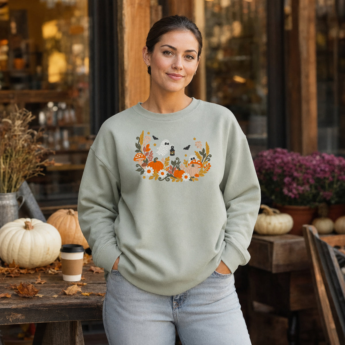 Sage floral ghost mushroom and pumpkin embroidered sweatshirt at a fall market