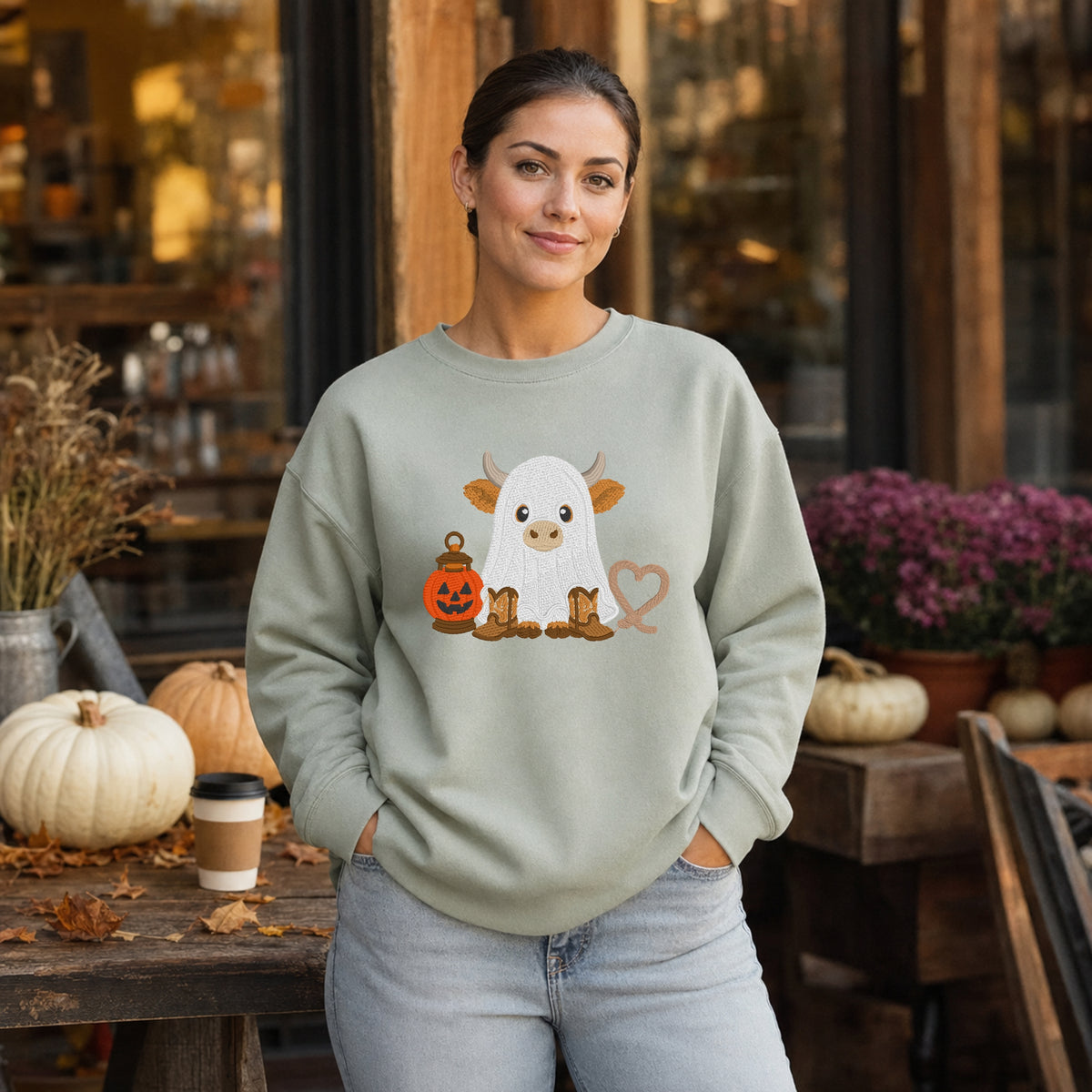Sage ghost cow embroidered Halloween sweatshirt worn at a fall pumpkin market