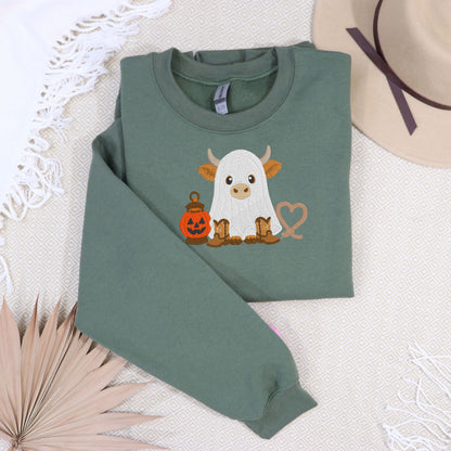 Sage embroidered ghost Highland cow Halloween sweatshirt cozy flat lay