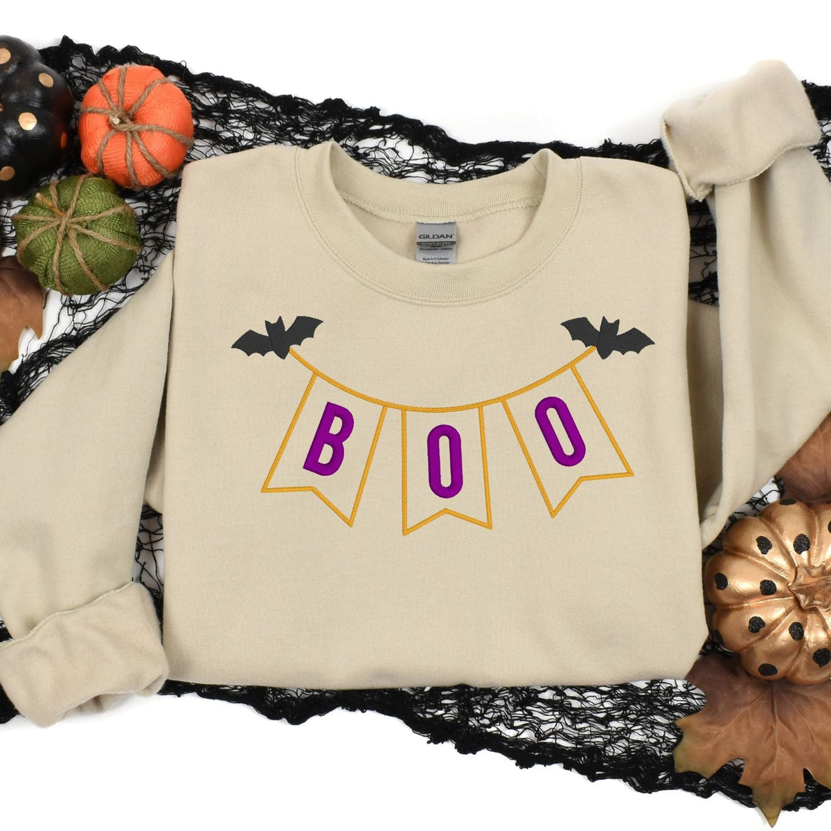 Sand embroidered BOO pennant banner sweatshirt Halloween flat lay