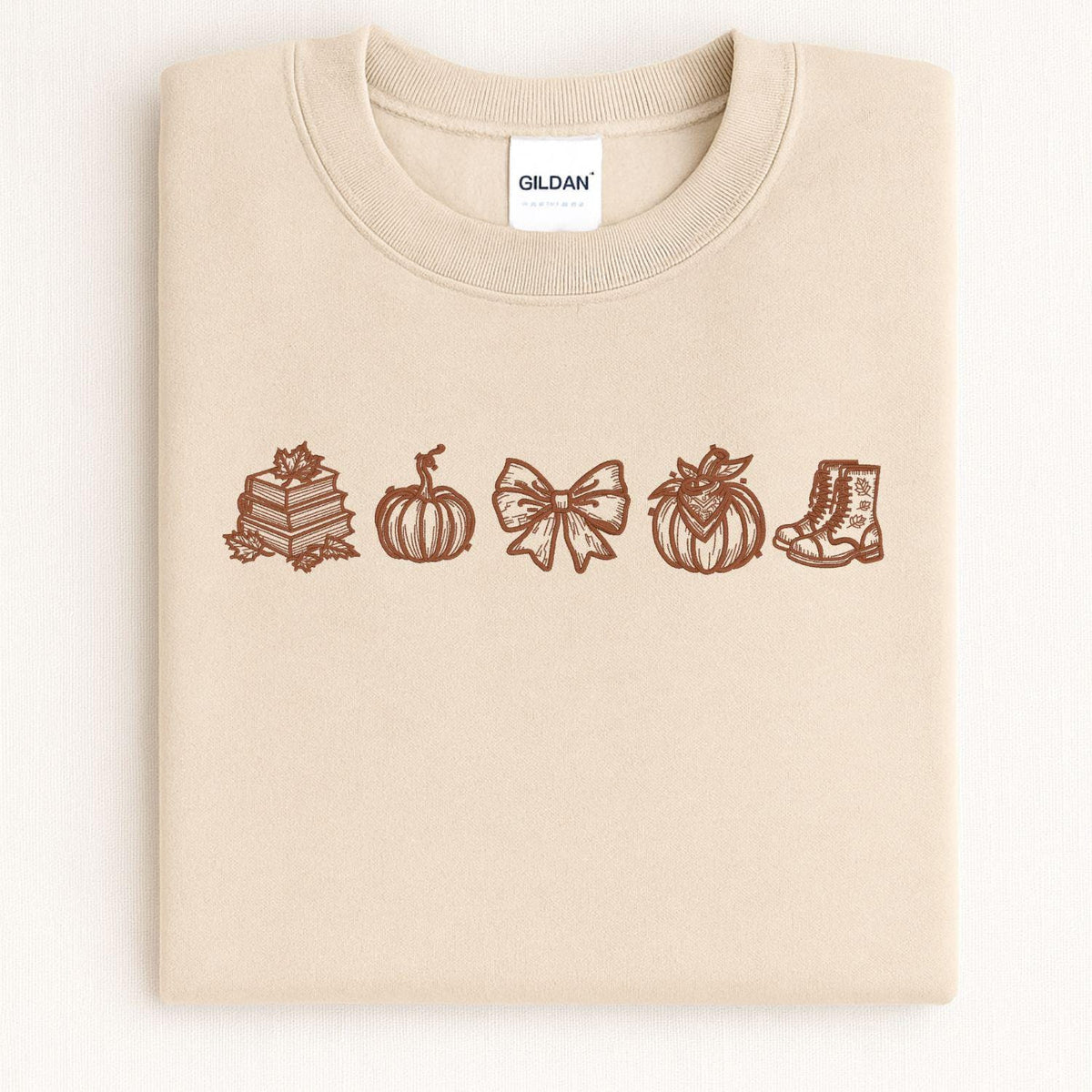 Sand Gildan sweatshirt with embroidered fall icons in brown thread