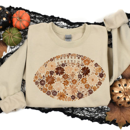 Sand floral football sweatshirt arranged with fall and football decorations