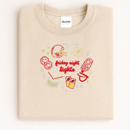Sand Gildan crewneck with embroidered football helmet, pom-poms, megaphone and drum