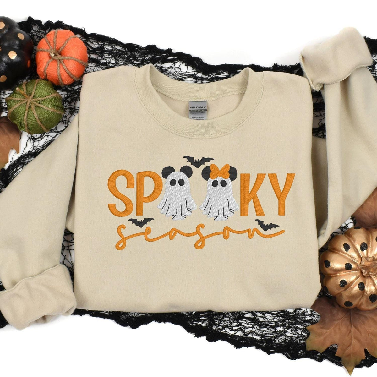 Sand ghost embroidered sweatshirt styled in a Halloween pumpkin flat lay