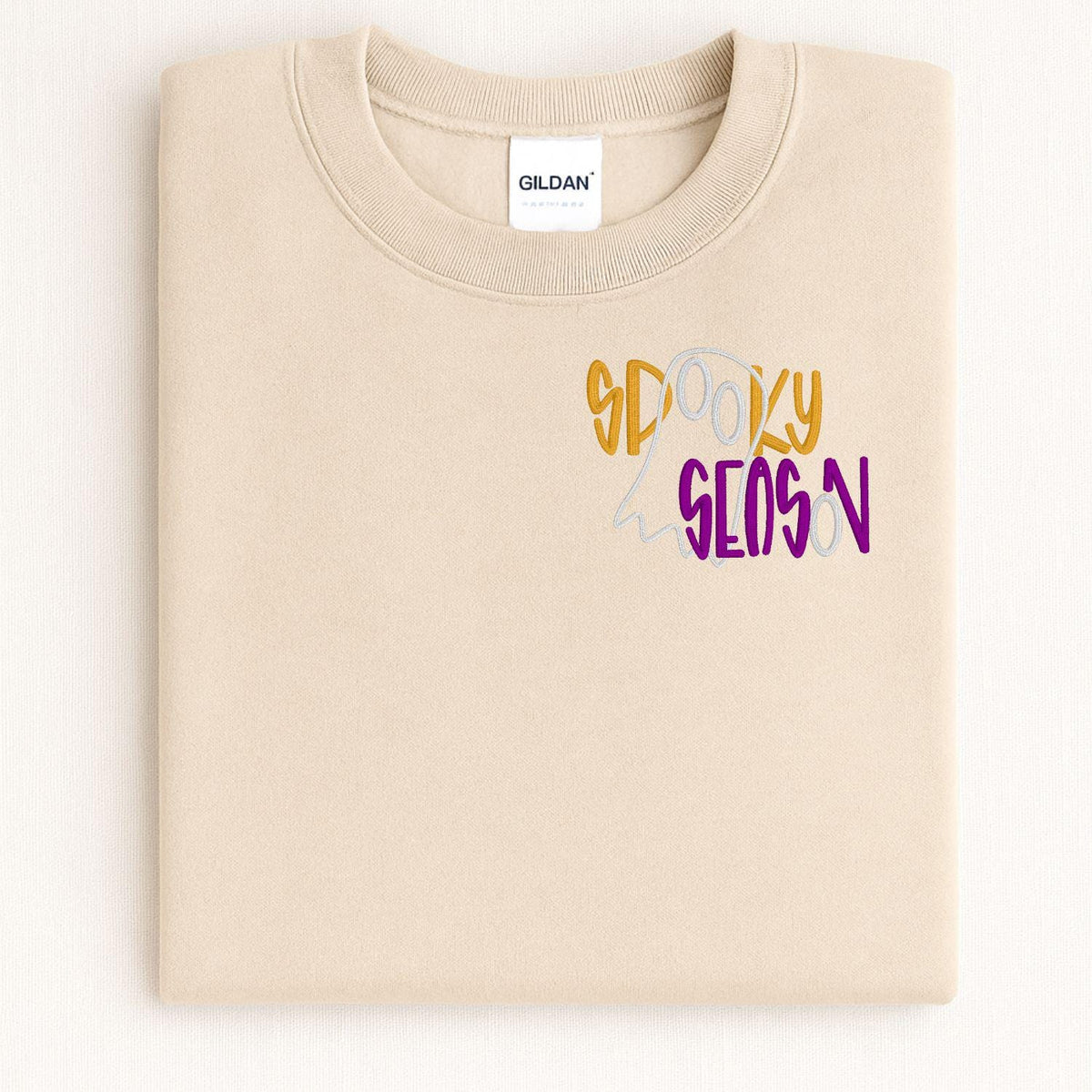 Folded Sand sweatshirt with colorful Spooky Season ghost embroidery