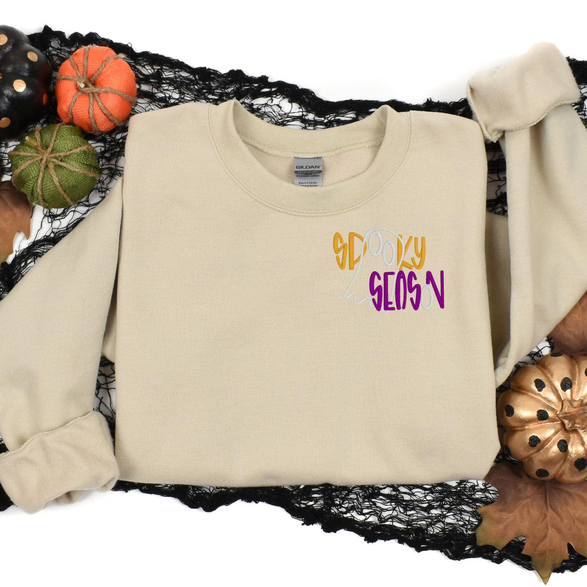 Sand Spooky Season ghost sweatshirt in a Halloween pumpkin flat lay