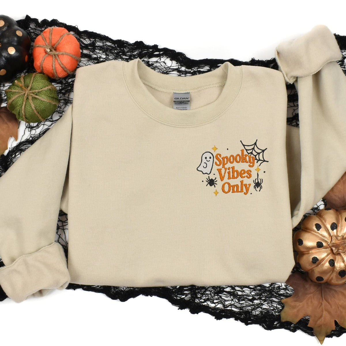 Sand Spooky Vibes Only embroidered sweatshirt styled with Halloween pumpkins