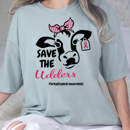 Close-up of the Save the Udders cow and pink ribbon graphic on a blue shirt