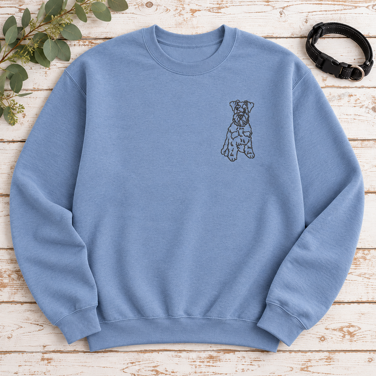 Stone Blue Gildan Softstyle sweatshirt flat lay with charcoal Schnauzer left chest embroidery