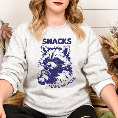 Model wearing ash gray Snacks Make Me Nicer raccoon sweatshirt