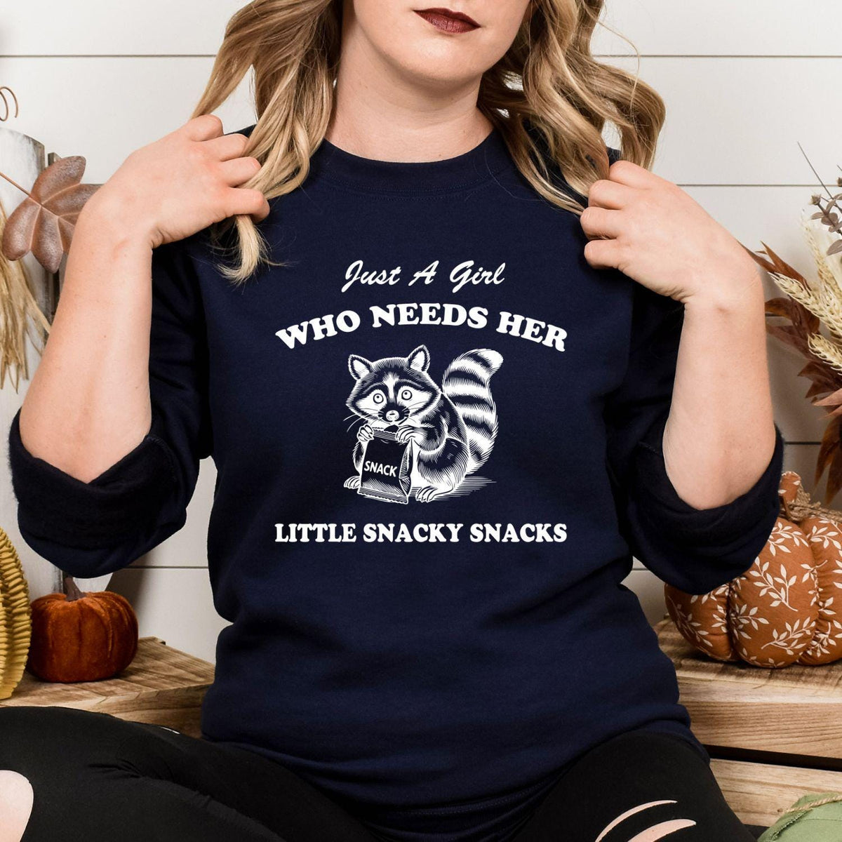 Navy Just a Girl snacky raccoon graphic sweatshirt modeled indoors