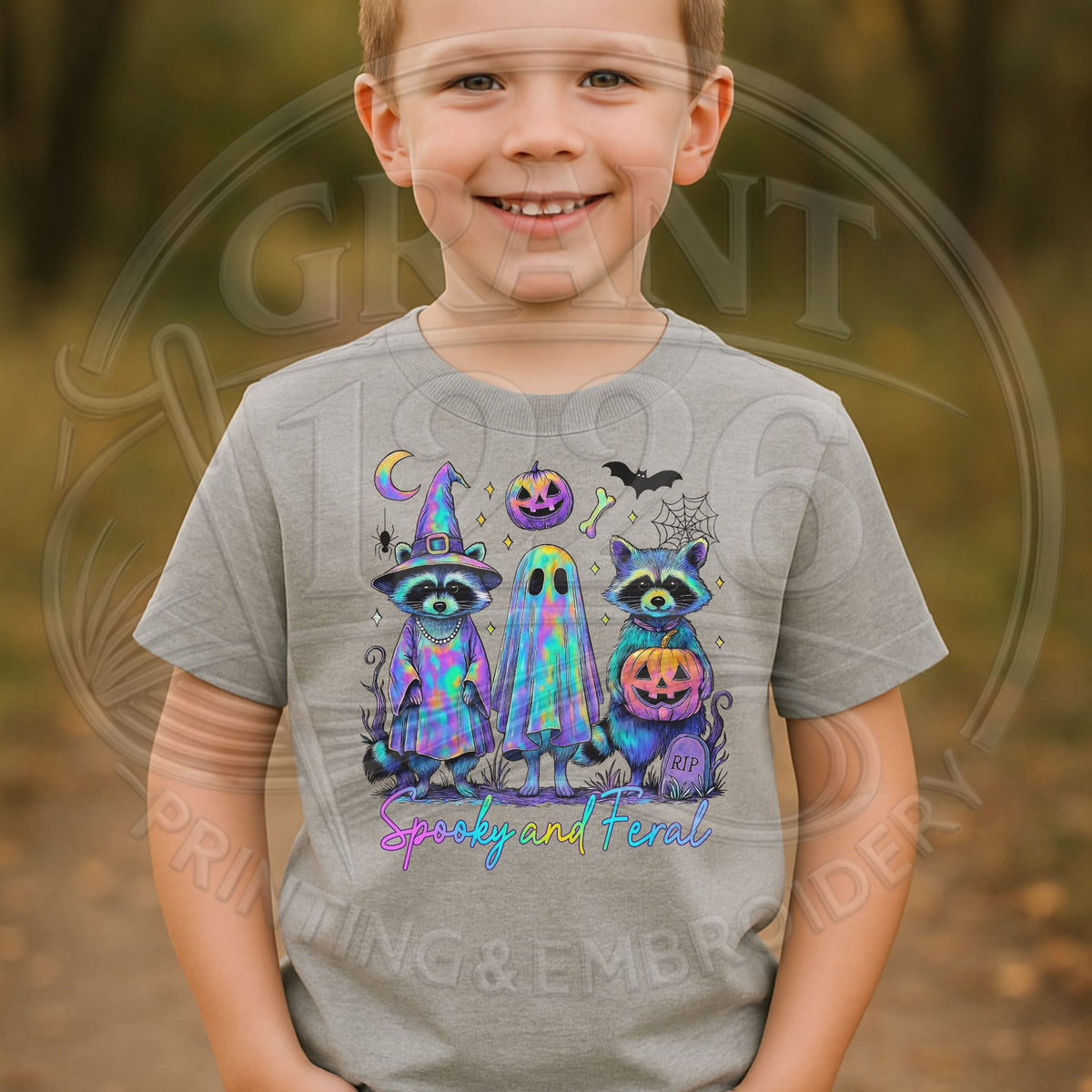 Child wearing gray Spooky and Feral Halloween raccoon graphic T-shirt