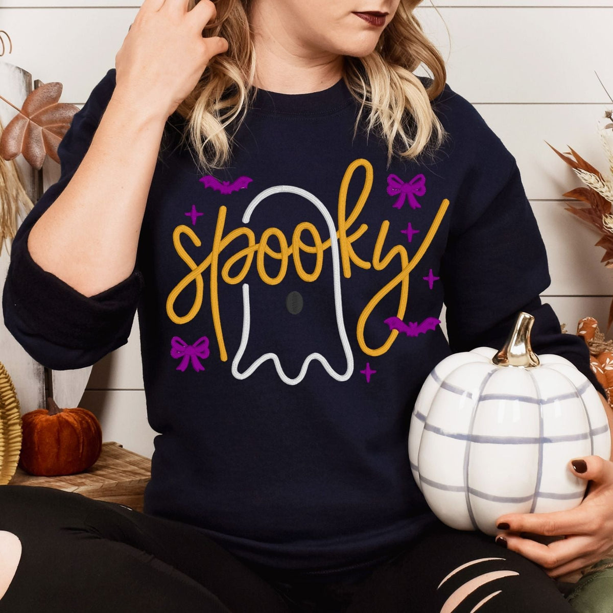 Navy Spooky ghost bow embroidered sweatshirt styled with a white pumpkin