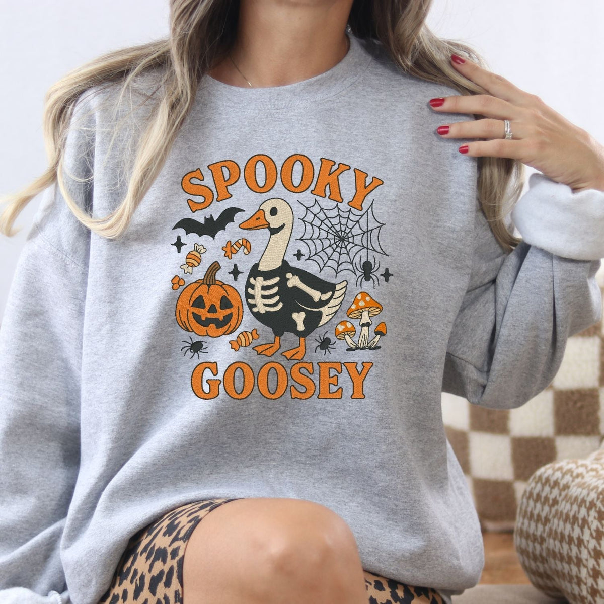 Ash Spooky Goosey embroidered Halloween sweatshirt with skeleton goose design