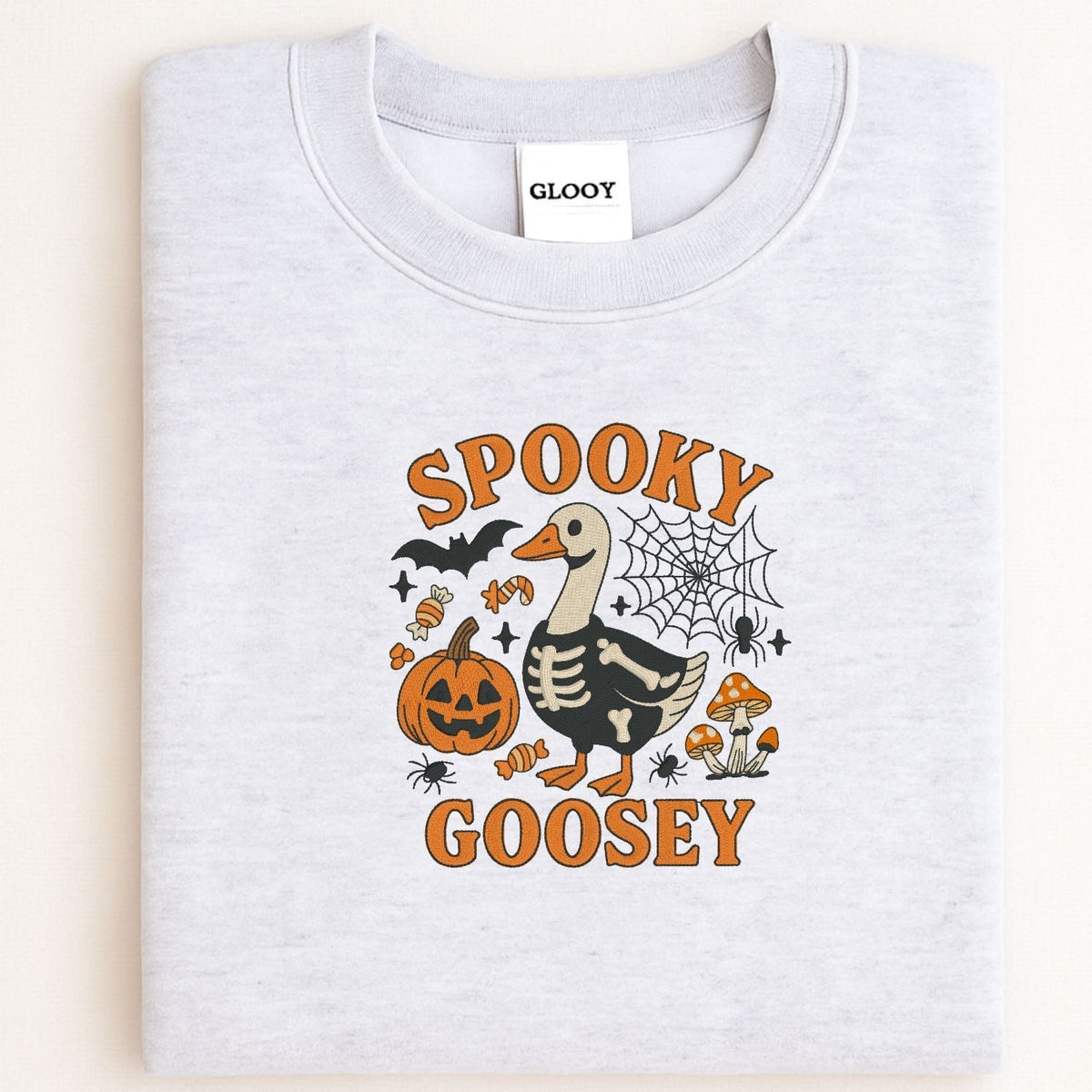Folded ash sweatshirt with orange and black Spooky Goosey Halloween embroidery