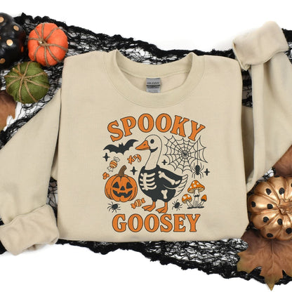 Sand Spooky Goosey sweatshirt flat lay with Halloween pumpkins and black lace