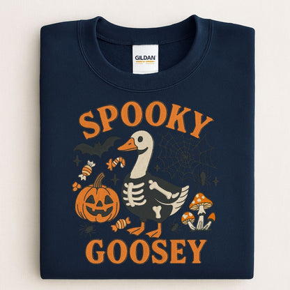 Folded navy Gildan sweatshirt with Spooky Goosey skeleton goose Halloween embroidery