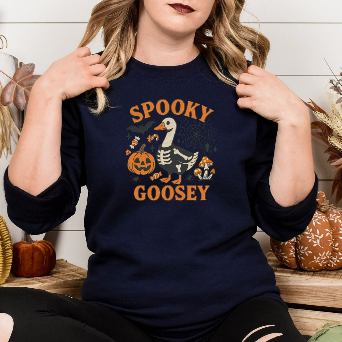 Navy skeleton goose embroidered crewneck styled for a fall Halloween outfit