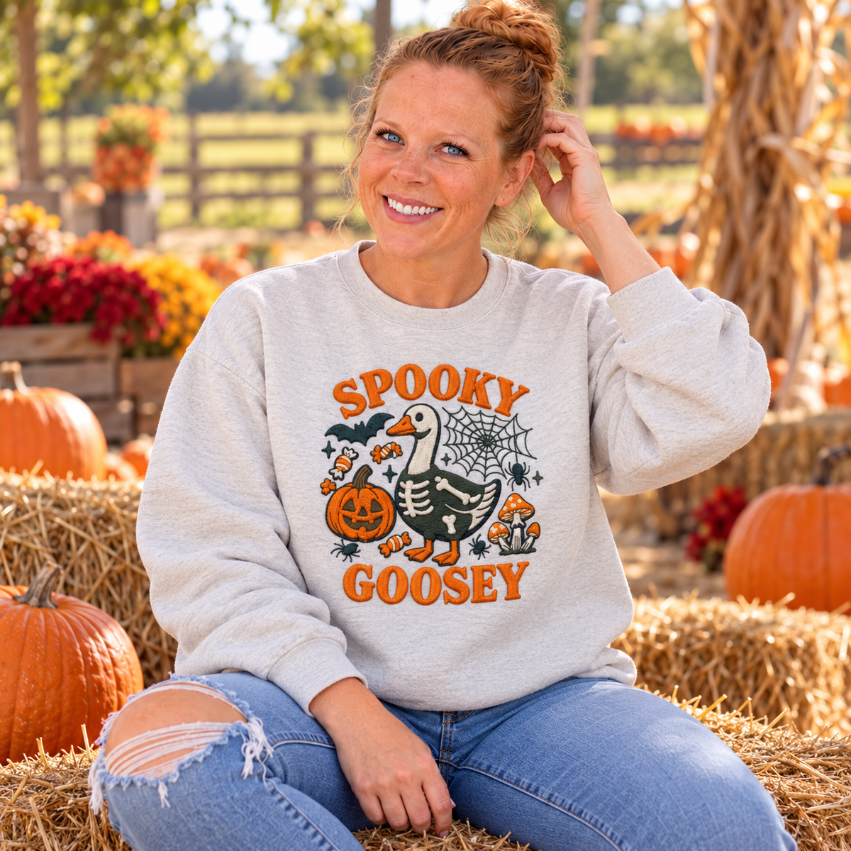 Woman wearing Ash Spooky Goosey embroidered sweatshirt at pumpkin patch