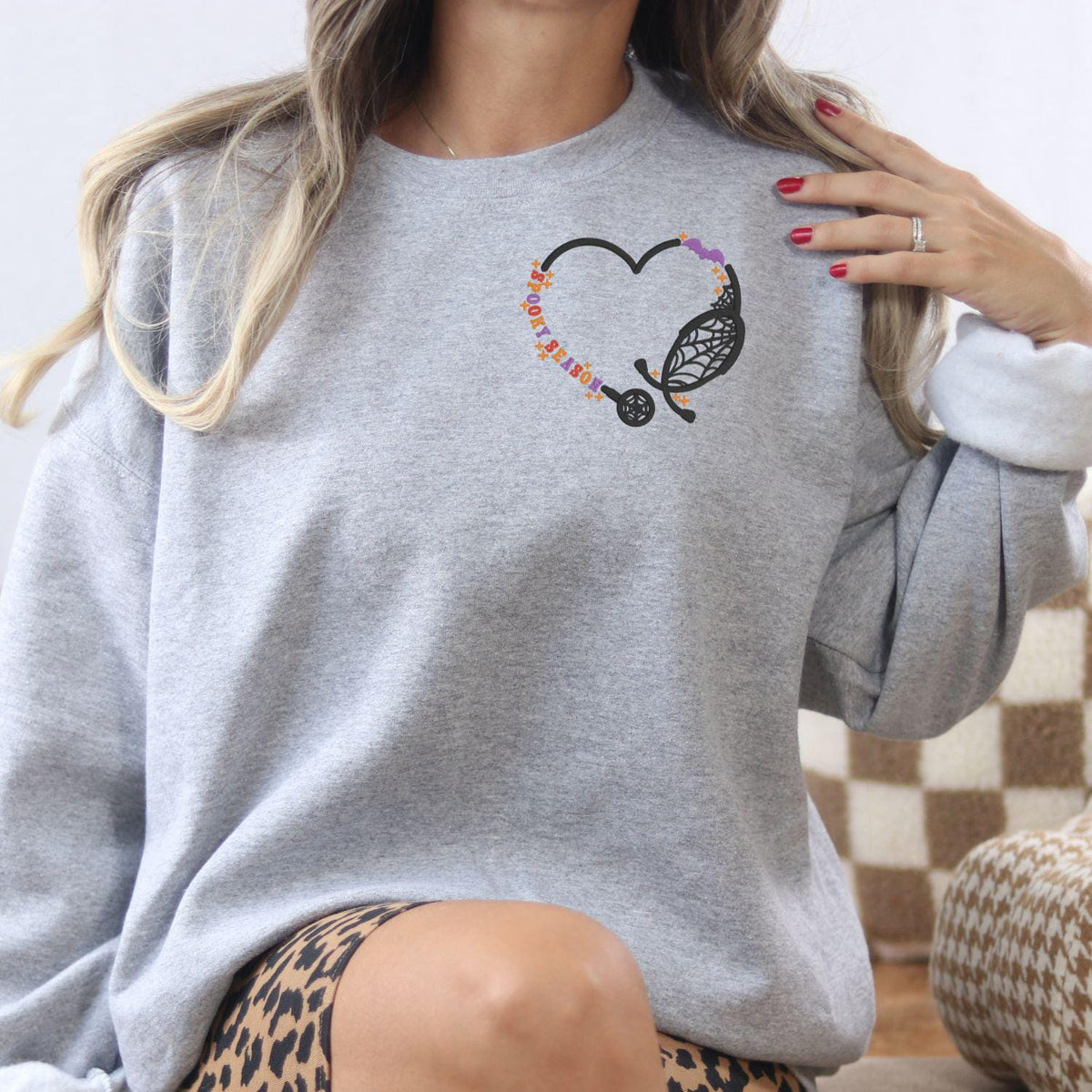 Ash spooky nurse embroidered crewneck with Halloween stethoscope design, lifestyle view