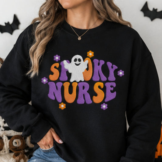 Woman wearing black Spooky Nurse embroidered Halloween sweatshirt with purple orange and white ghost design