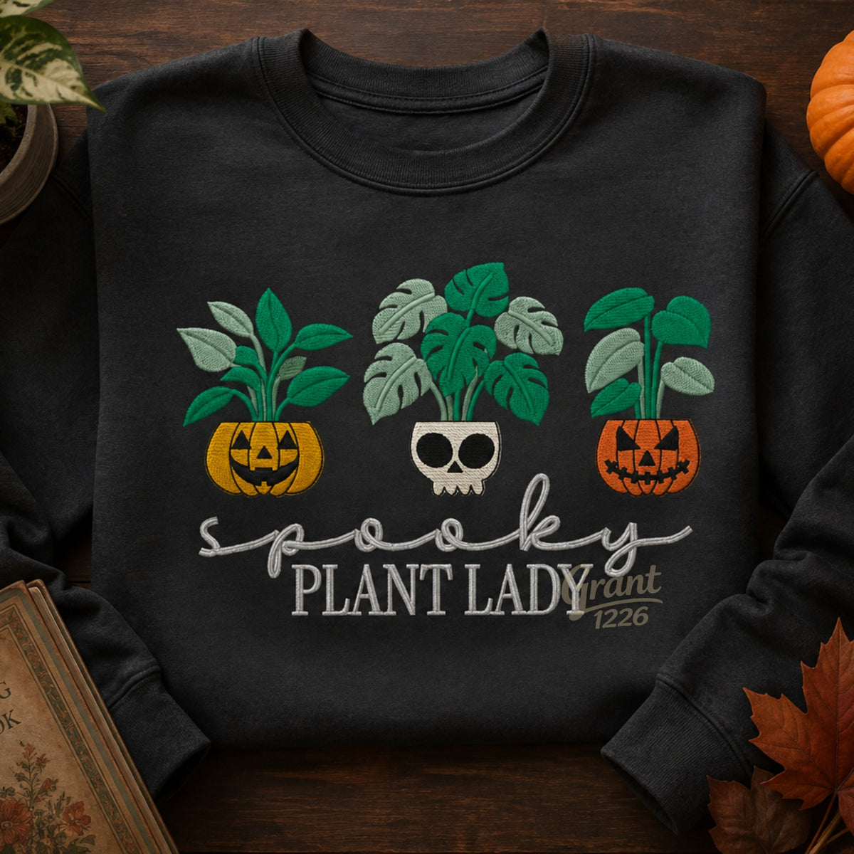 Charcoal Heather embroidered Spooky Plant Lady Gildan crewneck sweatshirt in fall flat lay.