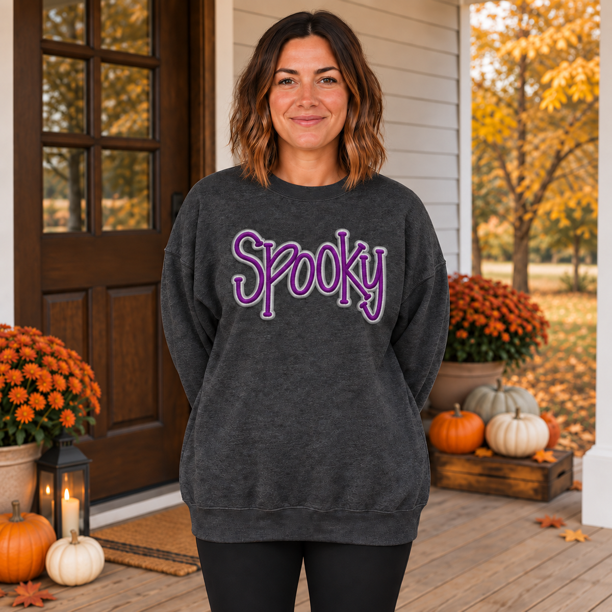 Adult woman wearing a heather black Spooky 3D puff embroidered crewneck with purple and silver thread