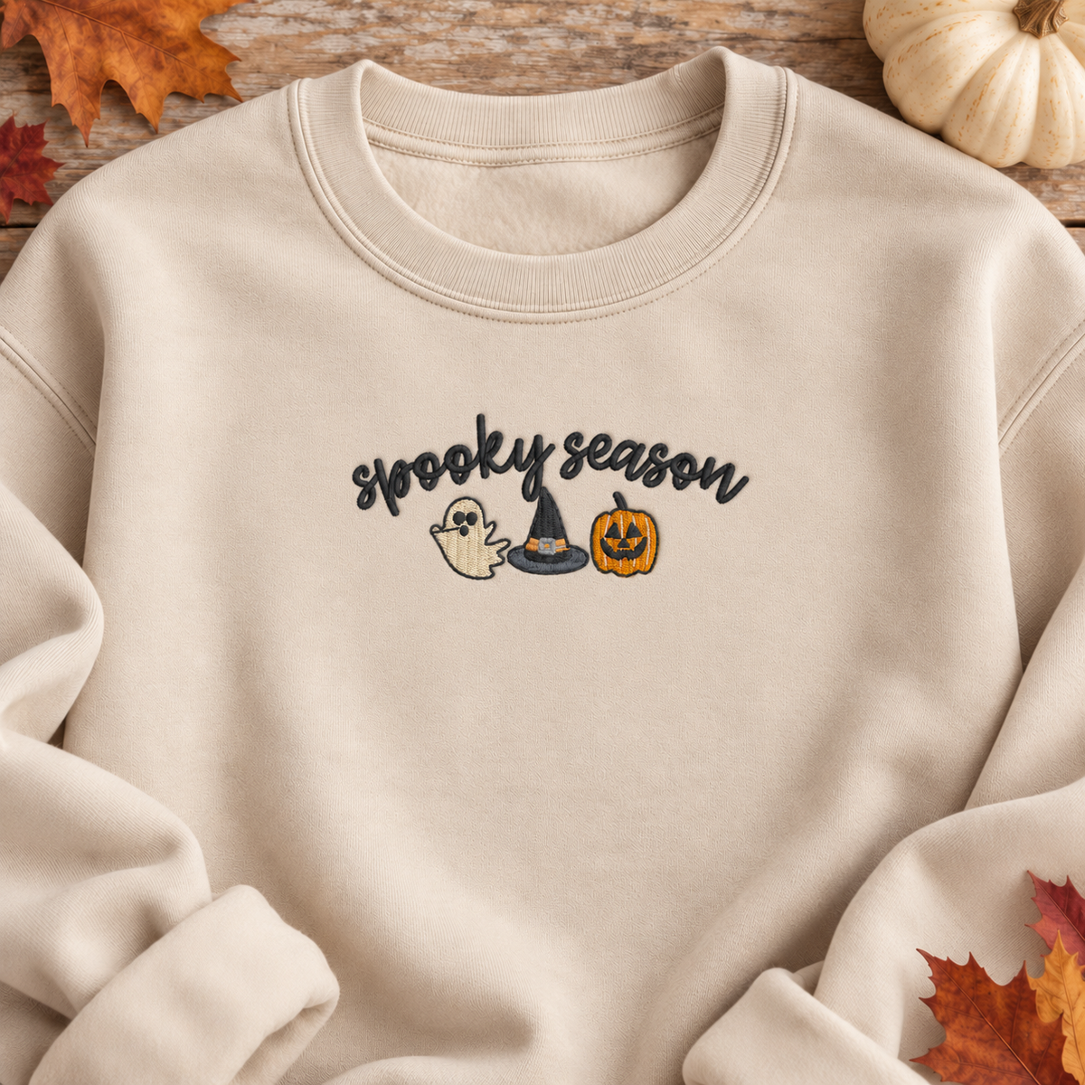 Close-up of the 8 by 3 inch Spooky Season ghost witch hat and pumpkin embroidery