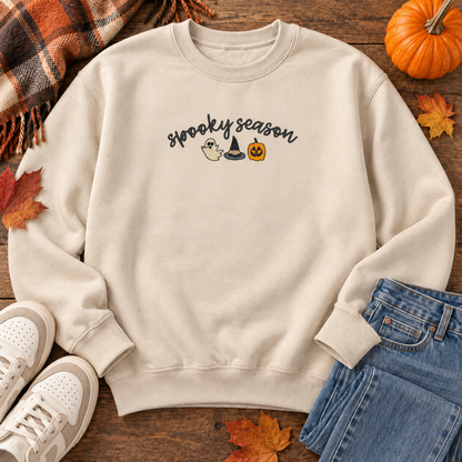 Sand sweatshirt flat lay showing the compact 8 by 3 inch Spooky Season embroidery