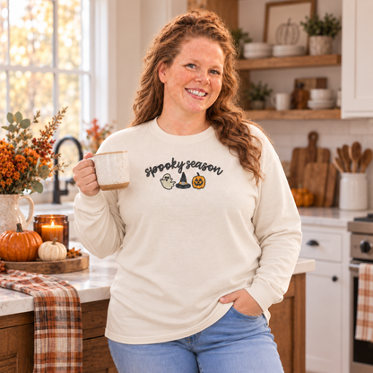Woman wearing an ivory Spooky Season embroidered long sleeve shirt in a fall kitchen