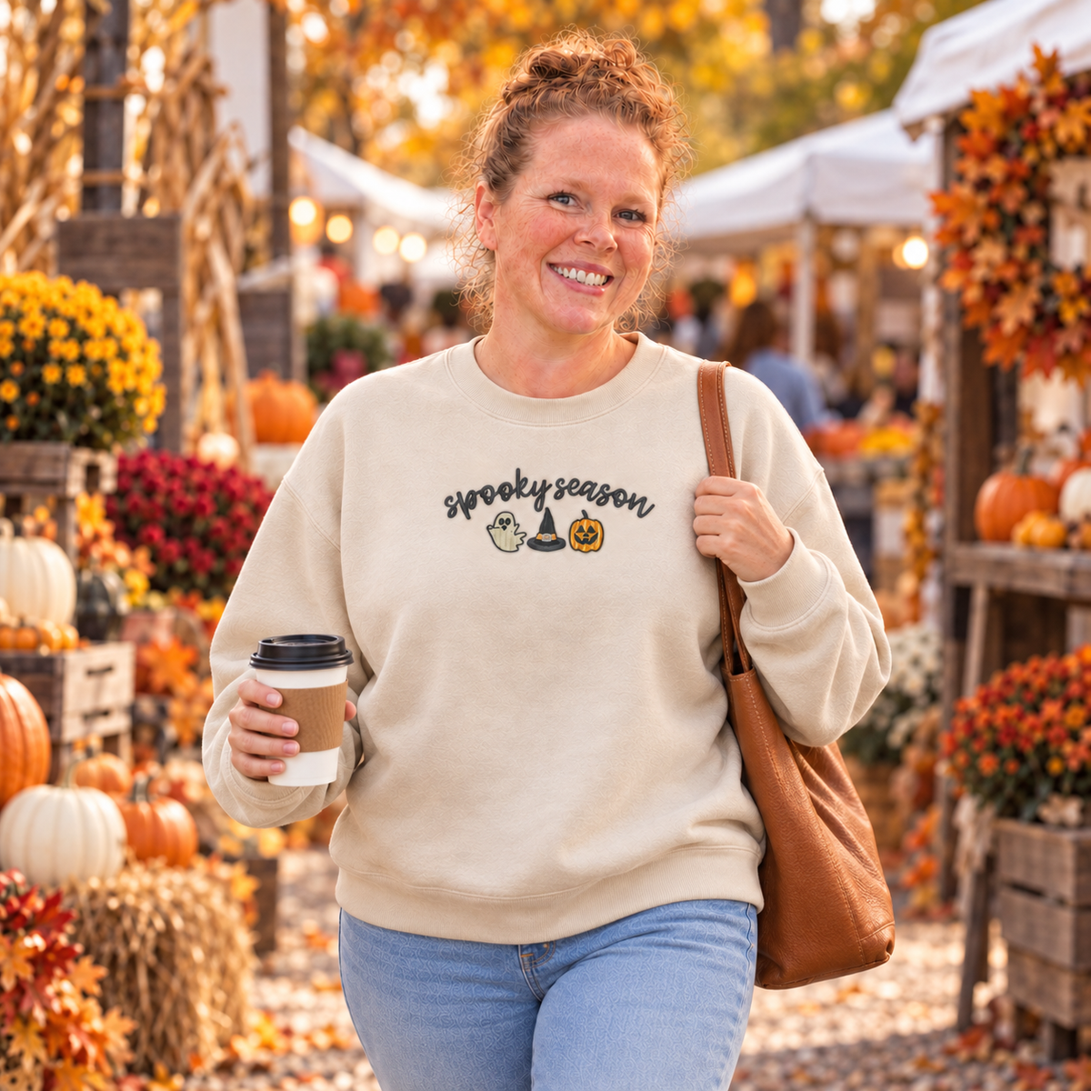 Sand Spooky Season embroidered sweatshirt worn at an autumn market