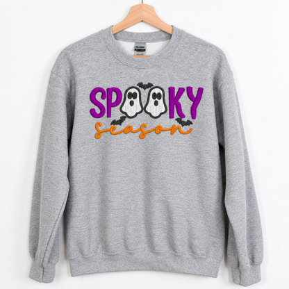 Spooky Season ghost embroidered Sport Grey sweatshirt on a wooden hanger, front view