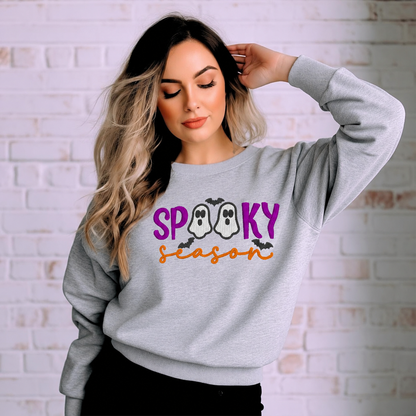 Woman modeling the Spooky Season ghost embroidered Sport Grey sweatshirt