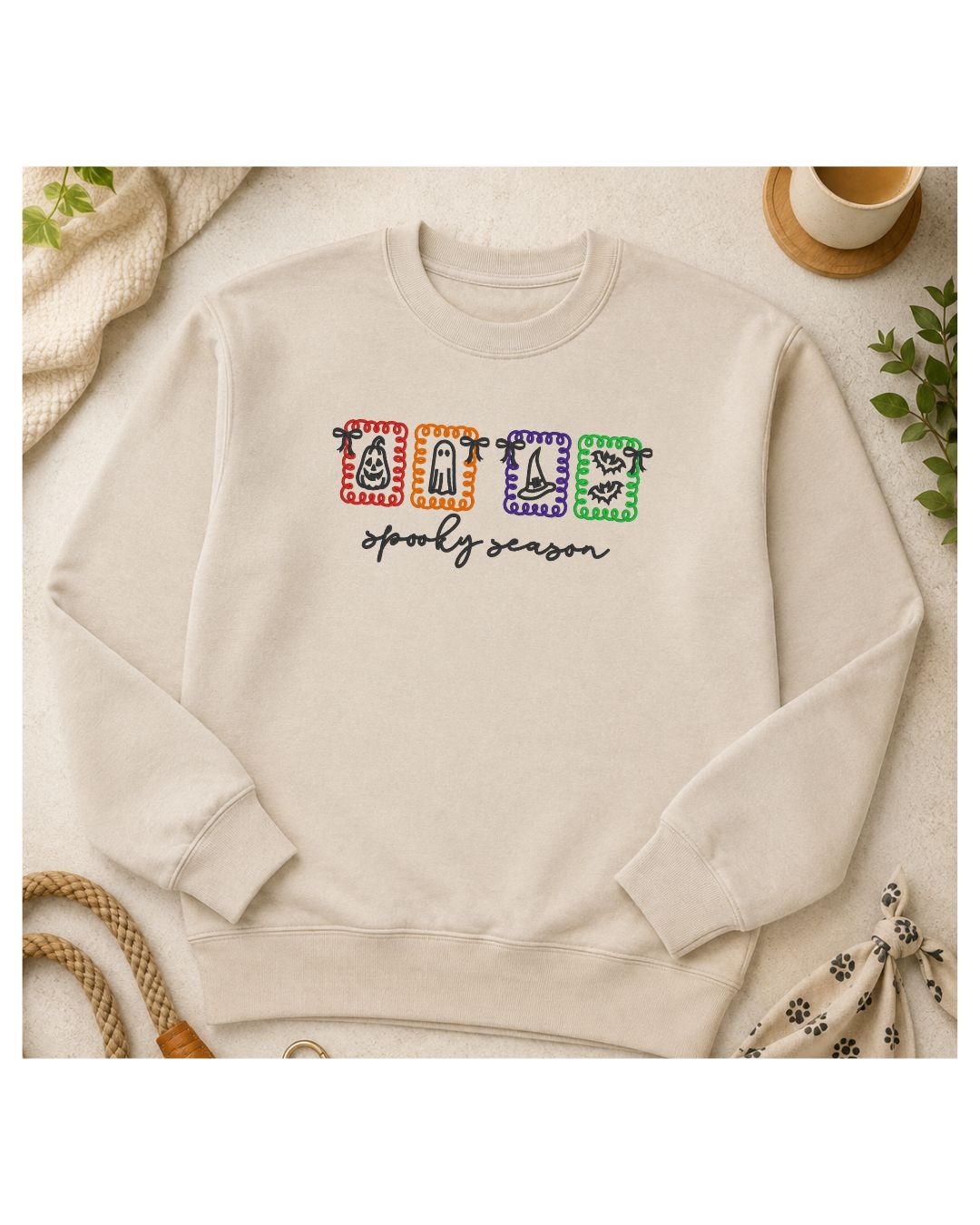 Ivory embroidered Spooky Season Halloween icons crewneck sweatshirt flat lay