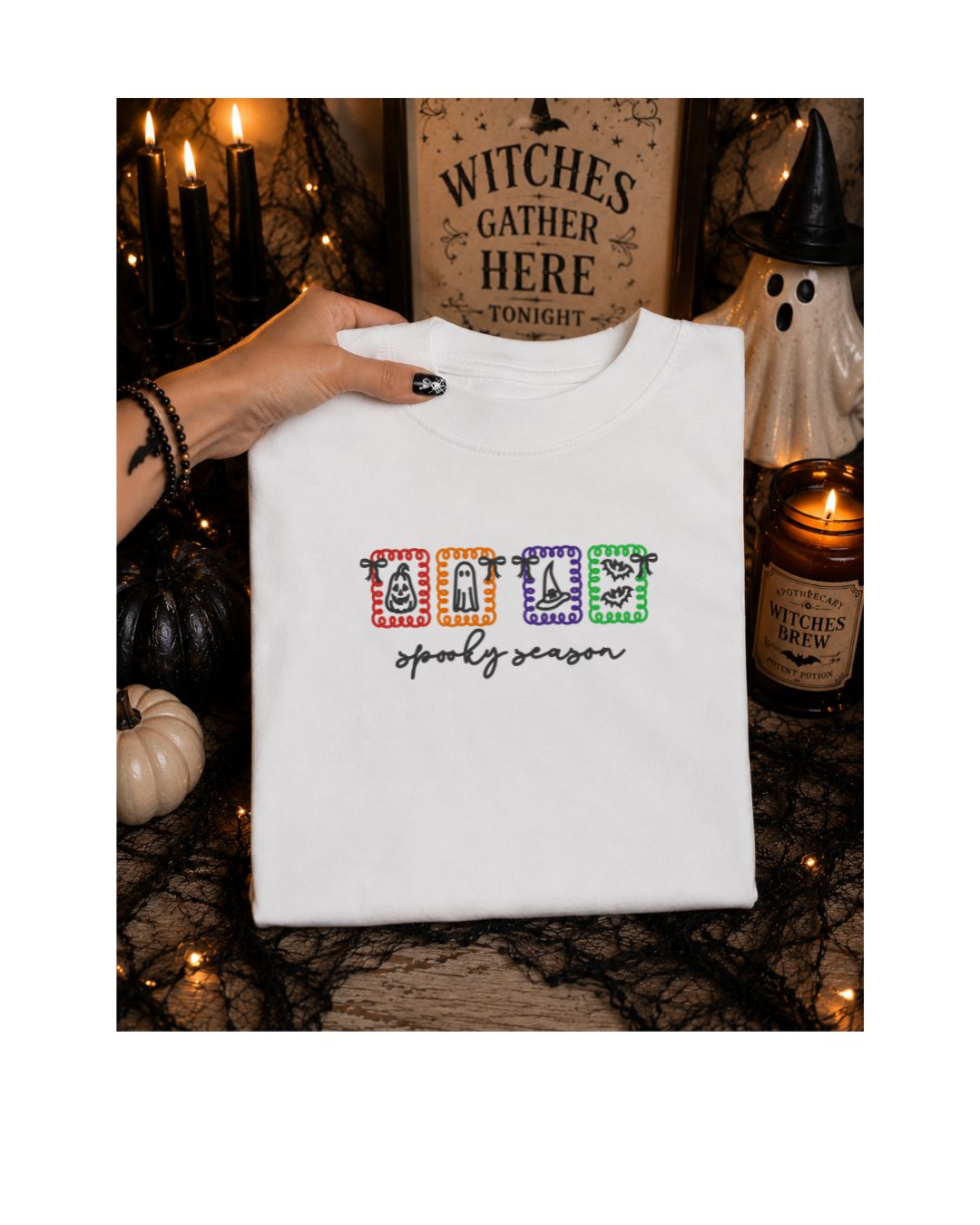 Ivory Spooky Season embroidered shirt with colorful pumpkin ghost witch hat and bat icons in a Halloween flat lay