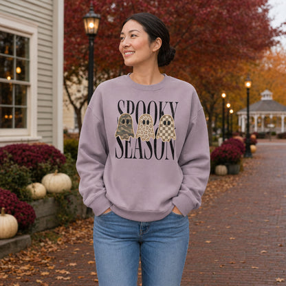 Woman wearing a Paragon Gildan Softstyle Spooky Season patchwork ghost sweatshirt in an autumn town