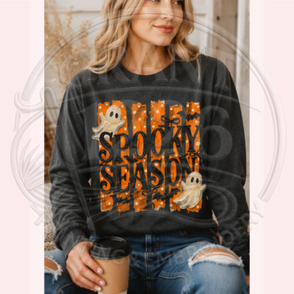 Woman wearing Pepper Comfort Colors Spooky Season long sleeve shirt with ghost and bat Halloween artwork