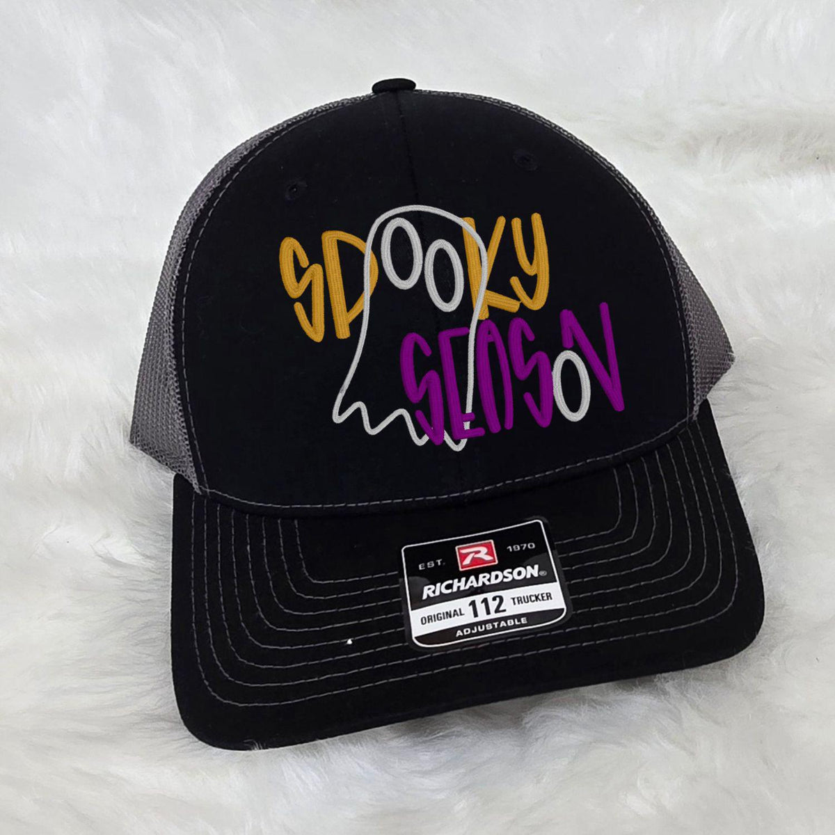 Angled view of a Richardson 112 hat with colorful Spooky Season ghost embroidery